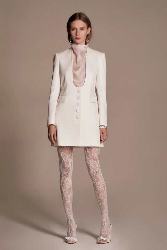 Luxuriously made from silk and cotton twill, this tailored blazer dress layered with a mesh silk top lends both trendy and timeless.