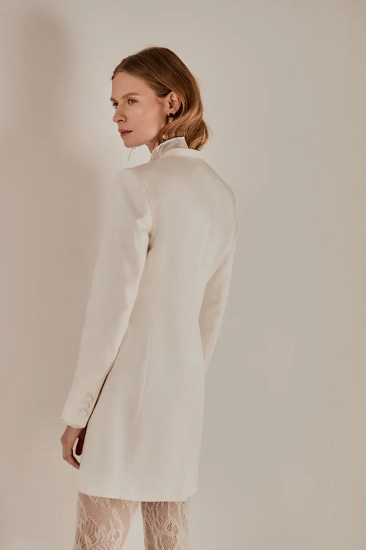 Luxuriously made from silk and cotton twill, this tailored blazer dress layered with a mesh silk top lends both trendy and timeless.