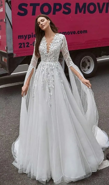 Real fairy gown for a romantic bride. The corset is embroidered with silver sequins and 3D lace and has V-neckline. The decorations proceed to the sleeves, that end with long straps of Tulle.