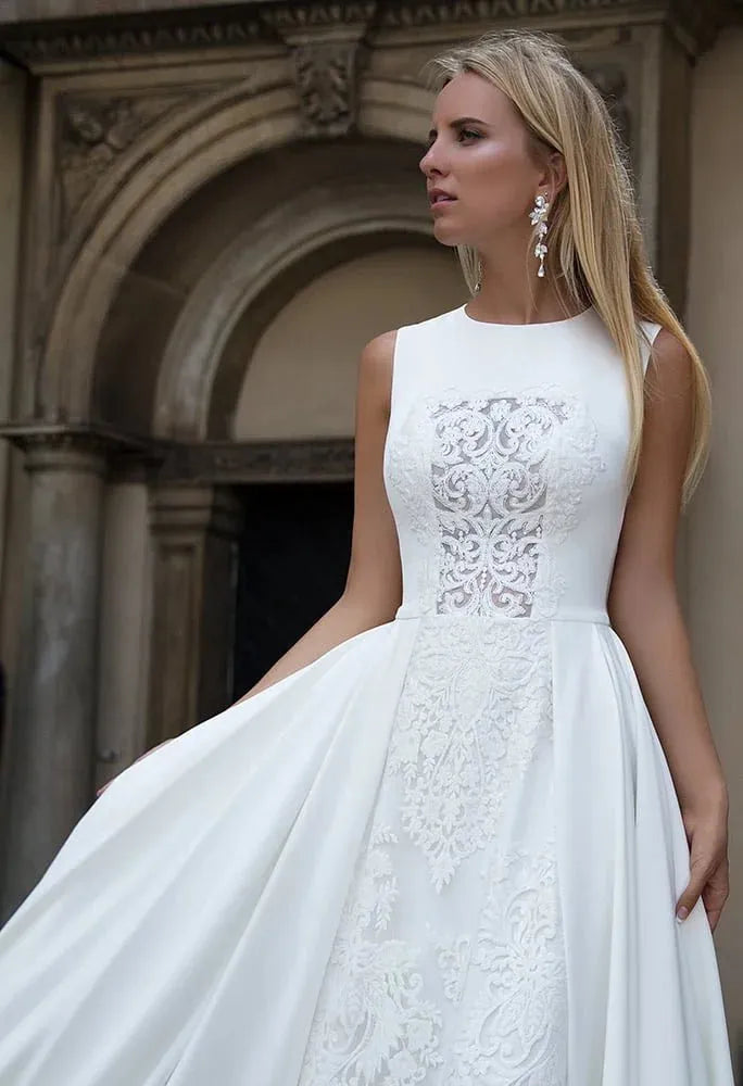 Sleek Sheath Wedding Gown with Strapless Jewel Neckline, Exquisite Lace Detailing, and a Flattering Dropped Waist for a Sophisticated and Timeless Bridal Look