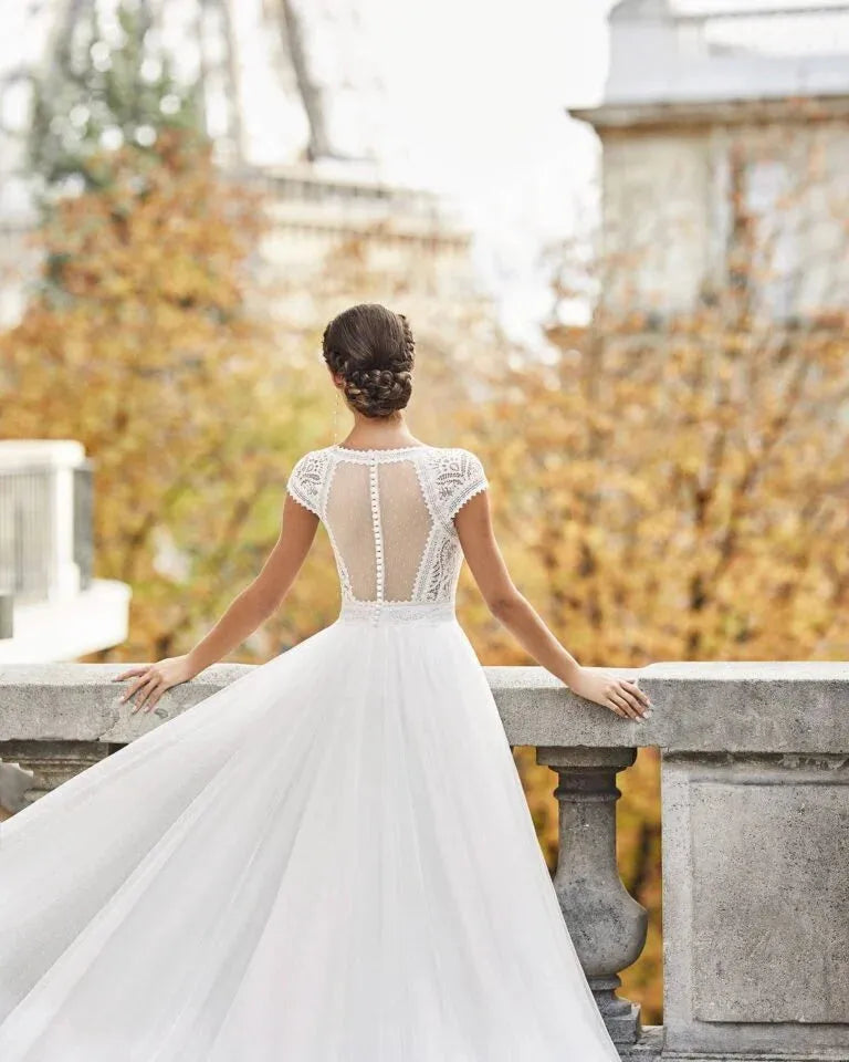 Charming A-Line Wedding Gown with Cap Sleeves, Elegant V-Neckline, and Delicate Lace Detailing for a Graceful Bridal Look
