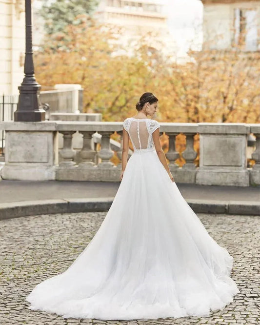 Charming A-Line Wedding Gown with Cap Sleeves, Elegant V-Neckline, and Delicate Lace Detailing for a Graceful Bridal Look