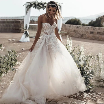 Breathtaking Strapless Wedding Dress Featuring Stunning Crystals Lace Appliques and Flowy A-Line Silhouette Bridal Dress White