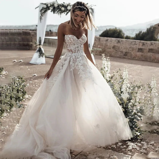Breathtaking Strapless Wedding Dress Featuring Stunning Crystals Lace Appliques and Flowy A-Line Silhouette Bridal Dress White