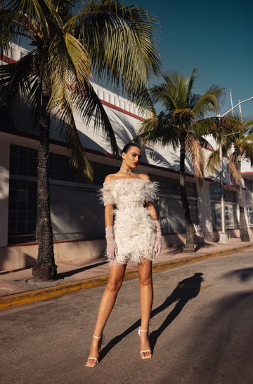 Ritzy long-sleeved mini wedding dress made from chantilly lace.