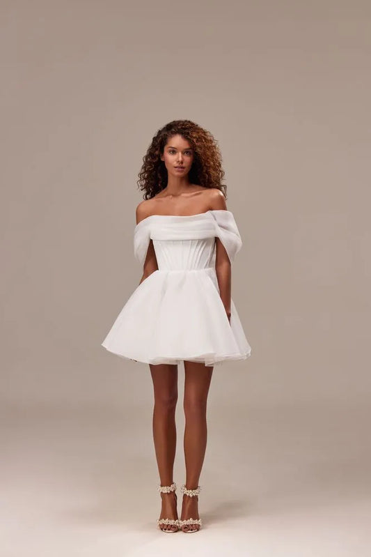Spectacular off-the-shoulder mini dress cut from flowy organza. Featuring a boned heart-shaped corset with a lace-up closure on the back, and a cute flaring mini skirt.