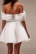 Spectacular off-the-shoulder mini dress cut from flowy organza. Featuring a boned heart-shaped corset with a lace-up closure on the back, and a cute flaring mini skirt.