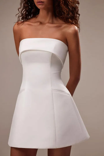 Showstopper mini wedding dress cut from satin. The sleeveless design features a straight neckline and a snatched waist that flows into a mini skirt.