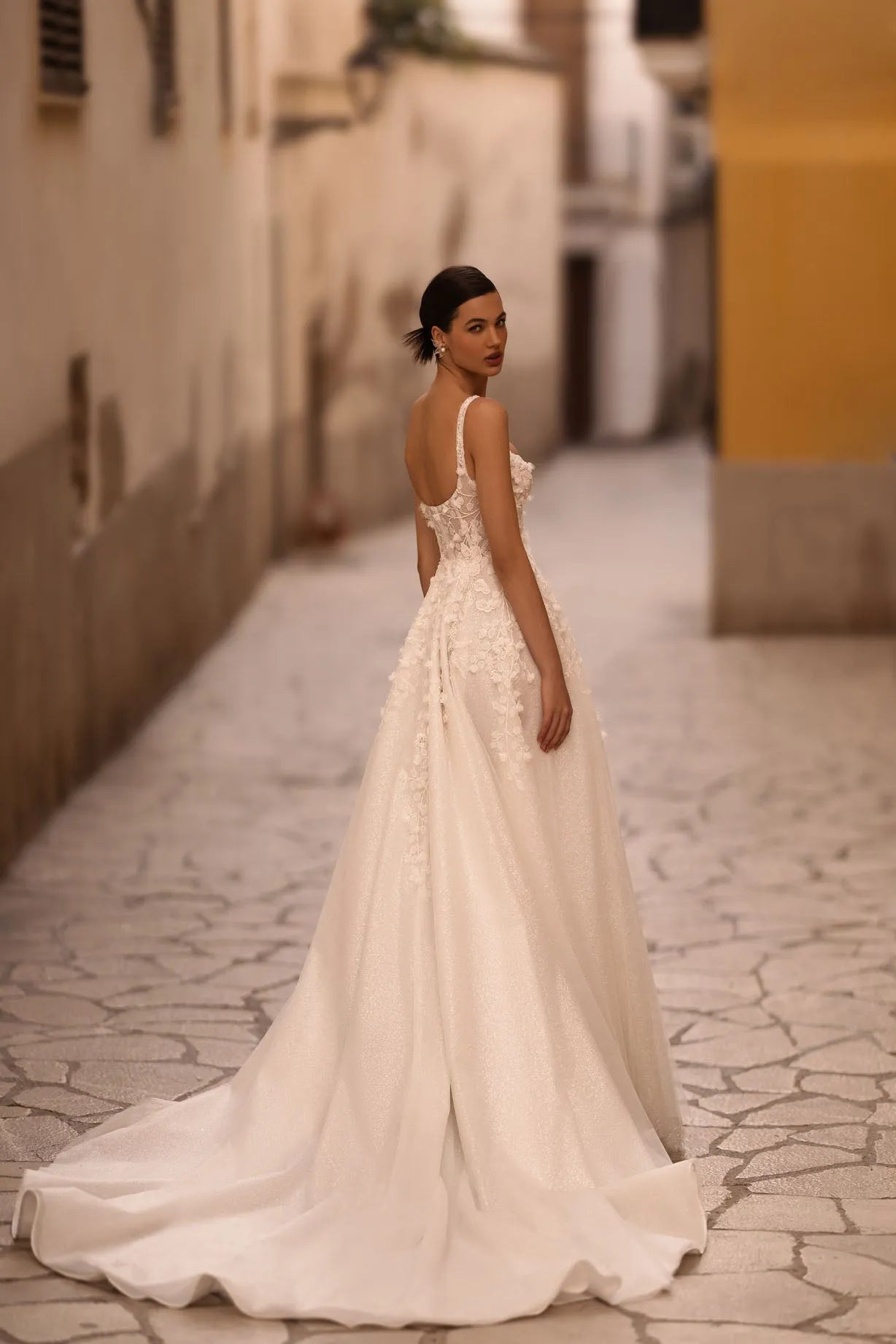 Introducing our captivating A-line wedding dress, a harmonious blend of shimmering elegance and delicate femininity. Crafted from luxurious shimmer fabric, it glimmers and shines with every step, emanating a mesmerizing radiance