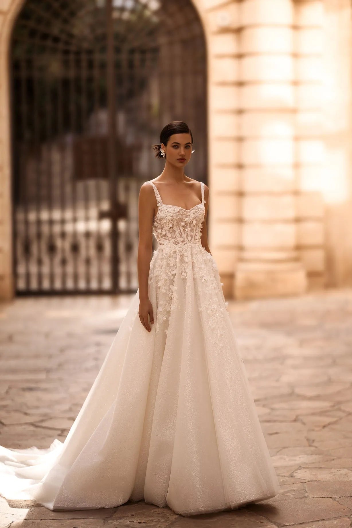 Introducing our captivating A-line wedding dress, a harmonious blend of shimmering elegance and delicate femininity. Crafted from luxurious shimmer fabric, it glimmers and shines with every step, emanating a mesmerizing radiance
