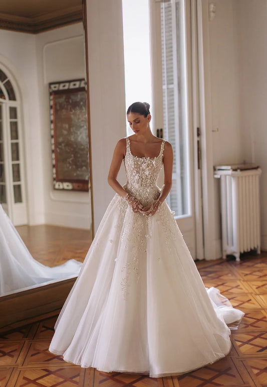Round neck sleeveless corset-based dress with meticulous embroideries on the top a detachable embroidered veil.