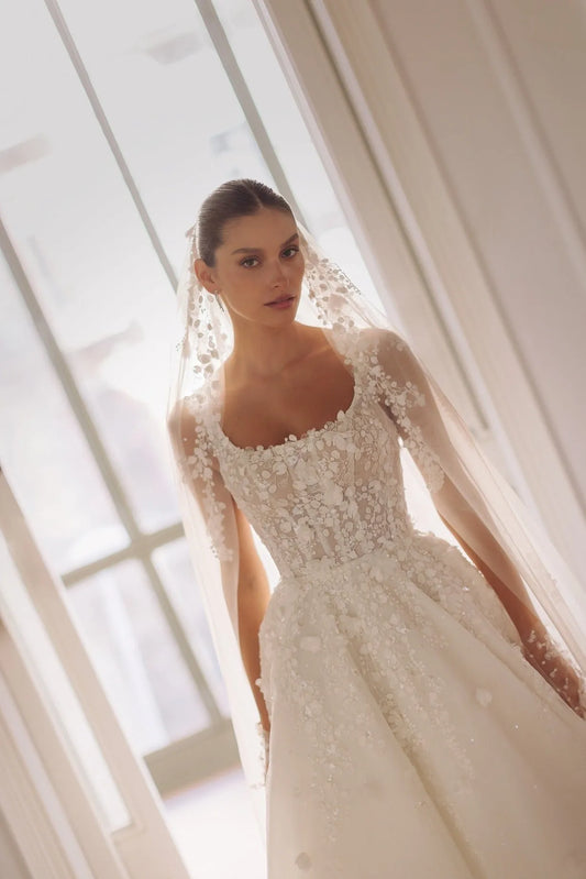 Round neck sleeveless corset-based dress with meticulous embroideries on the top a detachable embroidered veil.