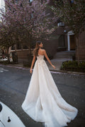 Expremely feminine and fragile wedding gown. The top is embellished with the scrunched up Tulle and floral elements that cover one shoulder. The skirt is made of numerous layers of Tulle with accentuated waistline and 3D floral lace.