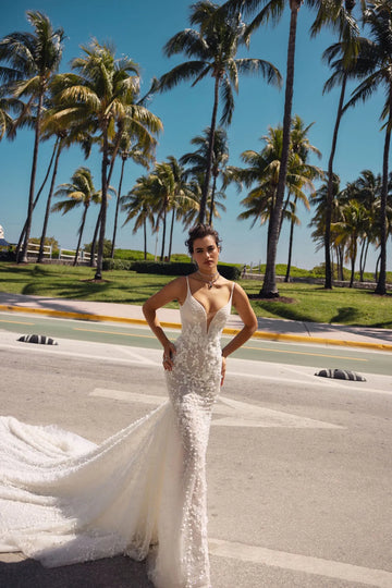 Bloom into a breathtaking bride in this floral lace mermaid wedding dress with a V-neckline and straps. The exquisite lace embellishments embrace your figure, flowing into a dramatic train, leaving a lasting impression on your big day.