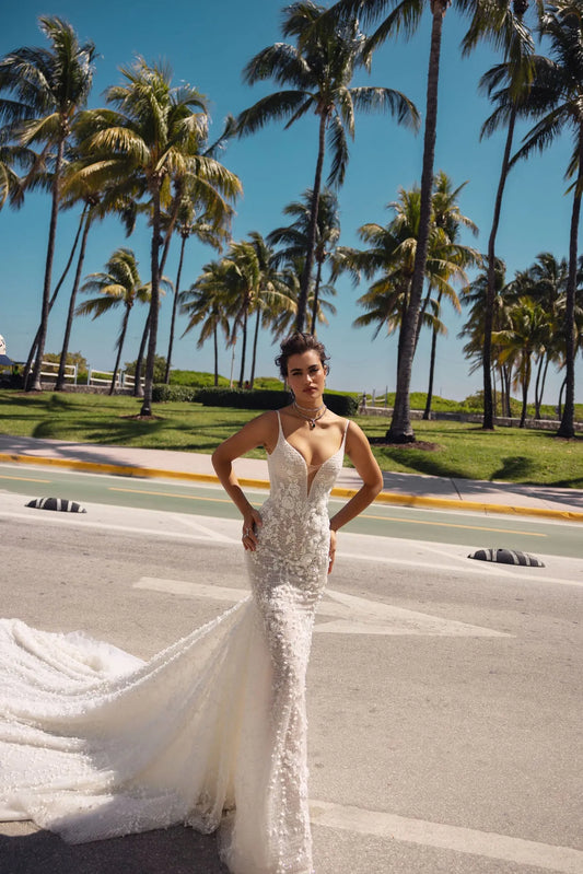 Bloom into a breathtaking bride in this floral lace mermaid wedding dress with a V-neckline and straps. The exquisite lace embellishments embrace your figure, flowing into a dramatic train, leaving a lasting impression on your big day.