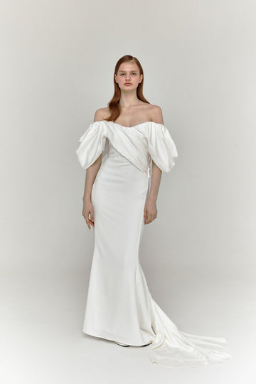 The draped off-shoulder asymmetrical neckline gives a modern take on a classic design wedding dress.