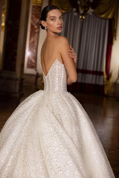 Exquisite Ball Gown Wedding Dress with Sleeveless Design, Deep Cut Neckline, and Sequined Embellishments