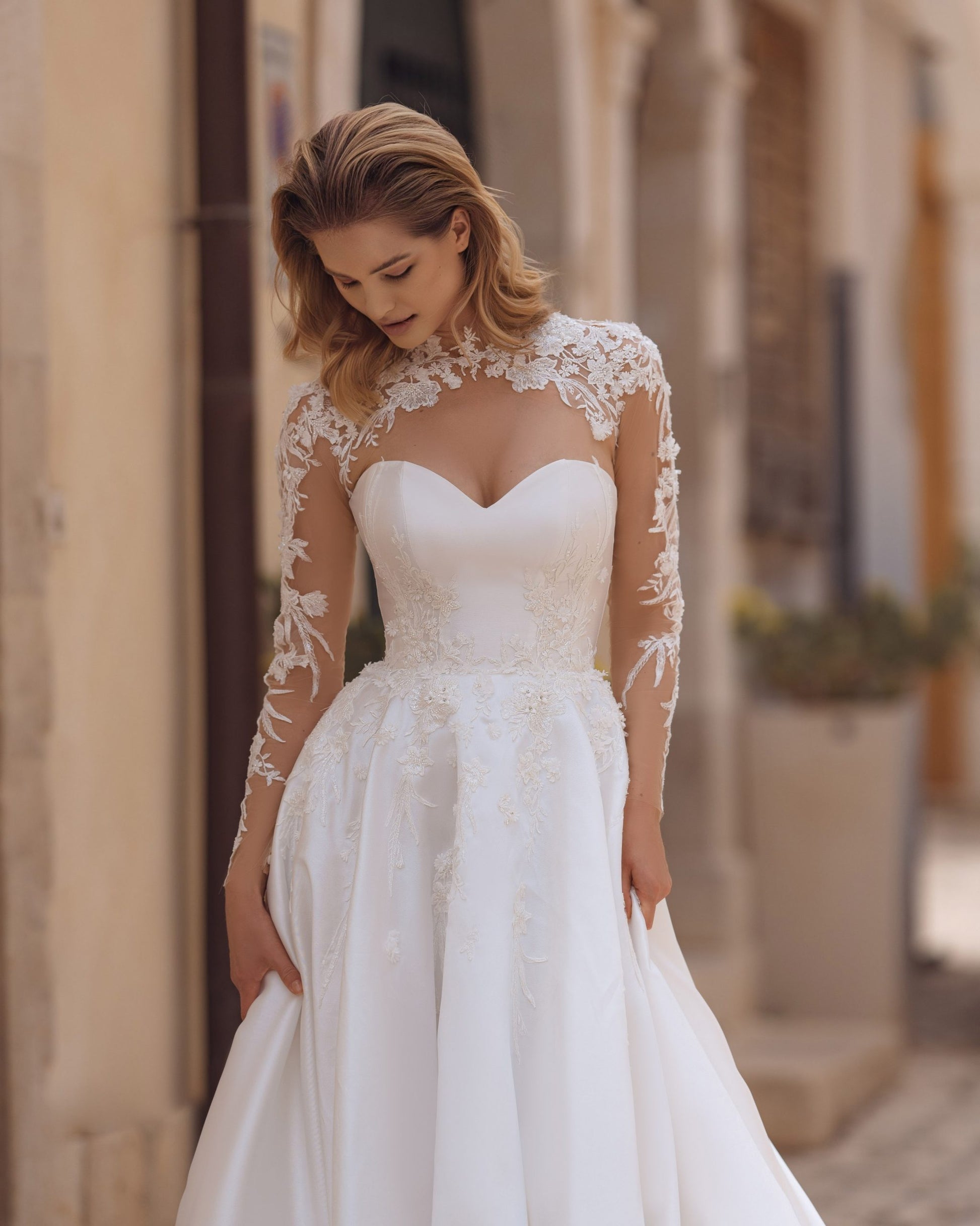 Exquisite A-Line Wedding Gown with Elegant Long Sleeves, a Dreamy Illusion Neckline, and Intricate Beaded Lace for a Timeless and Romantic Bridal Look