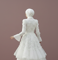 White wedding dress with a hijab on a plain background