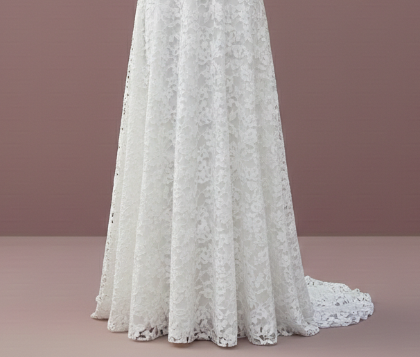 Woman wearing a white lace dress against a plain background