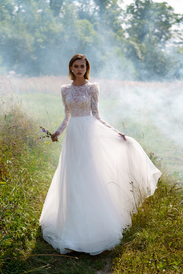 A-line wedding dress with long sleeves and closed back. The top is embroidered with lace. Ivory