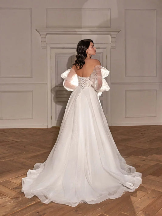 Classic A-Line Bridal Gown with Long Sleeves, Nude Neckline, Lace Embellishments, and Natural Waistline