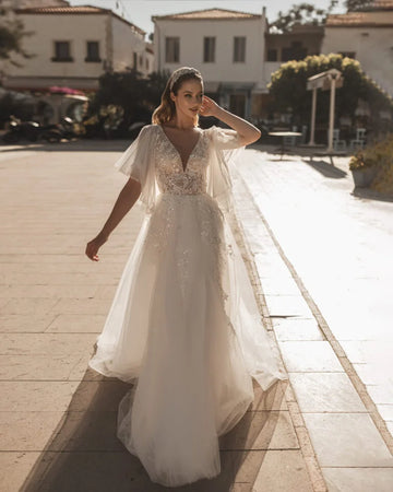 Romantic A-Line Bridal Dress with Bell Sleeves, Illusion Neckline, Glitter Embellishments, and Natural Waistline