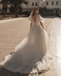 Romantic A-Line Bridal Dress with Bell Sleeves, Illusion Neckline, Glitter Embellishments, and Natural Waistline