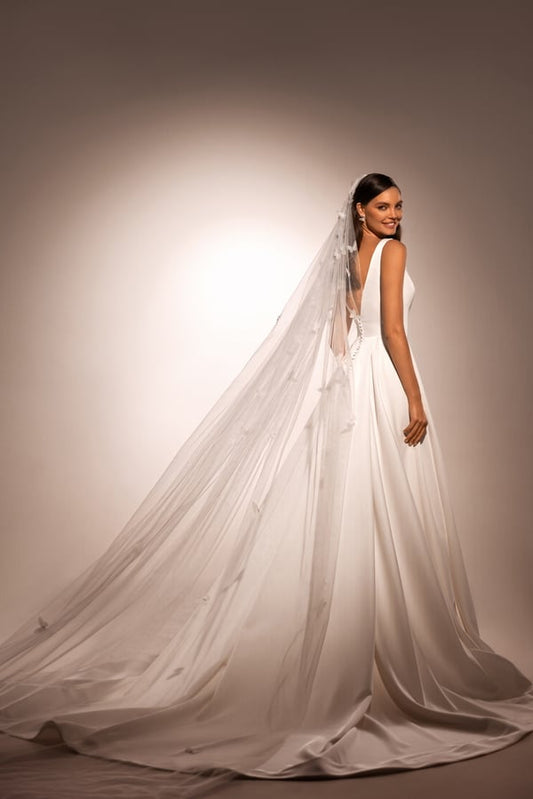 Sophisticated A-Line Wedding Gown with Deep Neckline, Sleeveless Design, and Button Embellishments