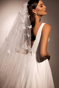 Sophisticated A-Line Wedding Gown with Deep Neckline, Sleeveless Design, and Button Embellishments