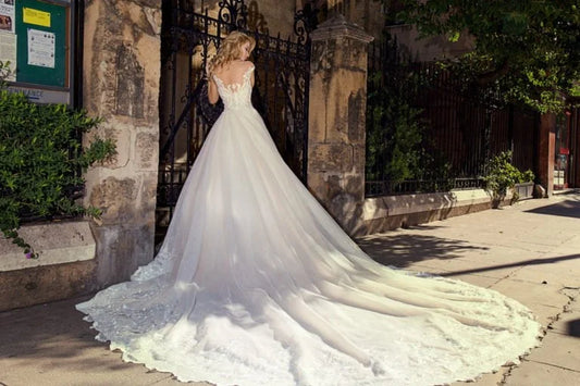 Opulent Ball Gown Wedding Dress with Strapless V-Neckline, Sparkling Beaded Lace Detailing, and a Flattering Dropped Waist for a Breathtaking Bridal Look