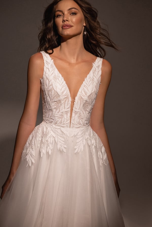 Graceful A-Line Wedding Dress with V-Neckline, Sleeveless Design, and Lace Embellishments