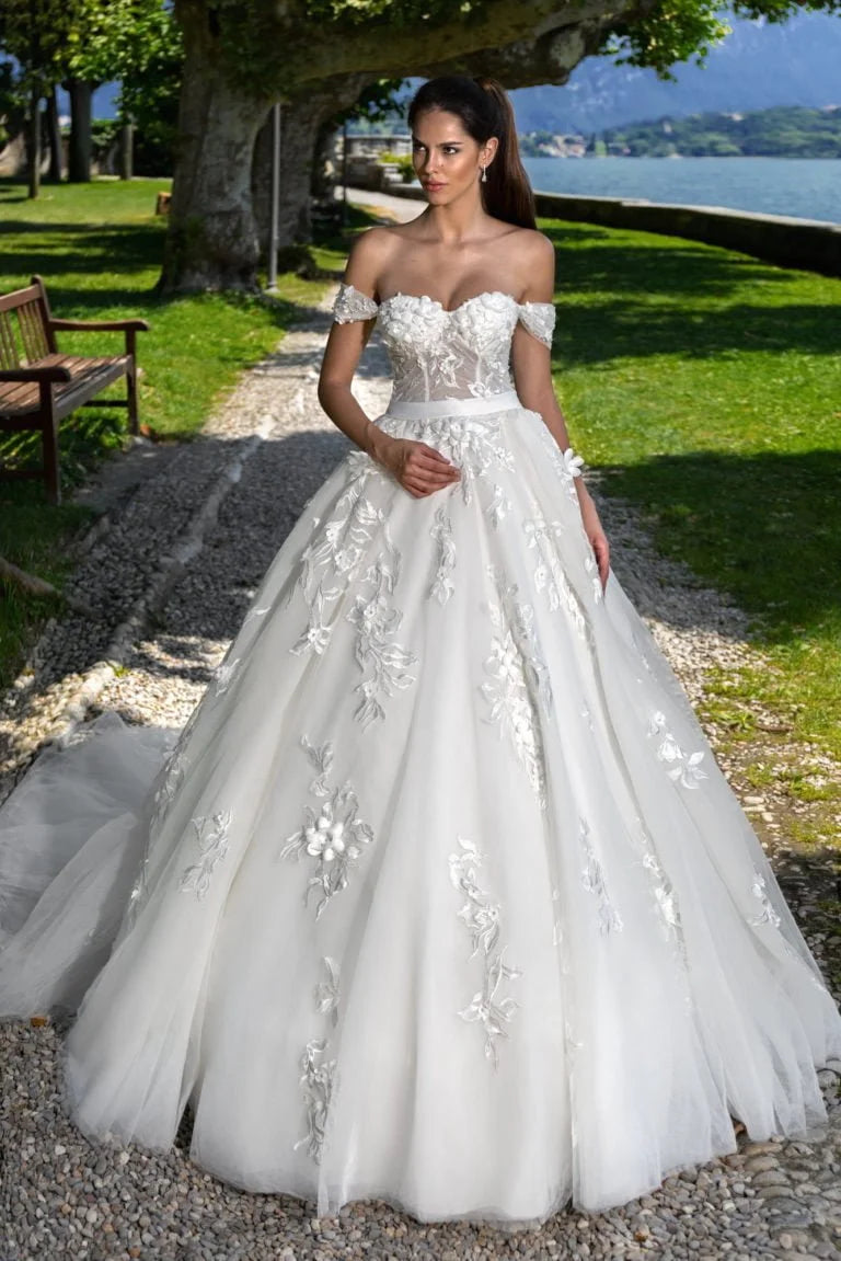 Majestic Ball Gown Wedding Dress with Off-the-Shoulder Neckline, Sparkling Beaded Lace Detailing, and a Flattering Dropped Waist for a Regal and Enchanting Bridal Look