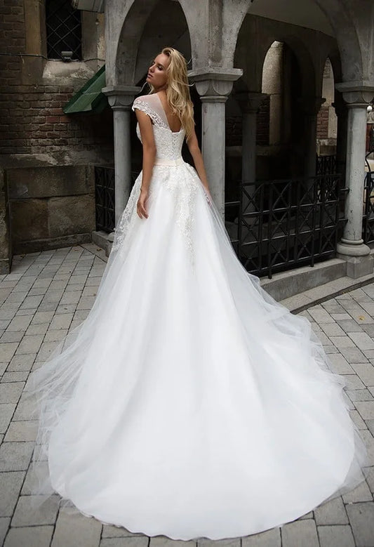 Graceful A-Line Wedding Gown with Strapless Illusion Neckline, Delicate Lace Detailing, and a Flattering Dropped Waist for an Enchanting Bridal Look