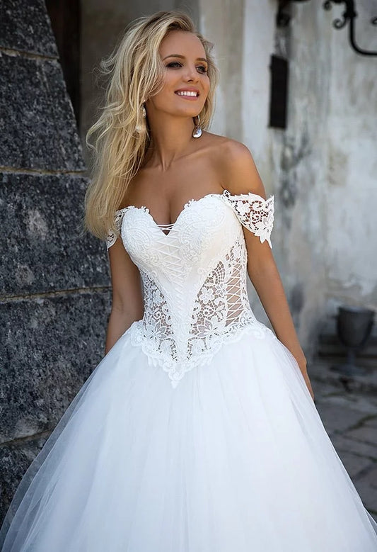 Regal Ball Gown Wedding Dress with Off-the-Shoulder Neckline, Exquisite Lace Detailing, and a Flattering Dropped Waist for a Fairytale Bridal Look