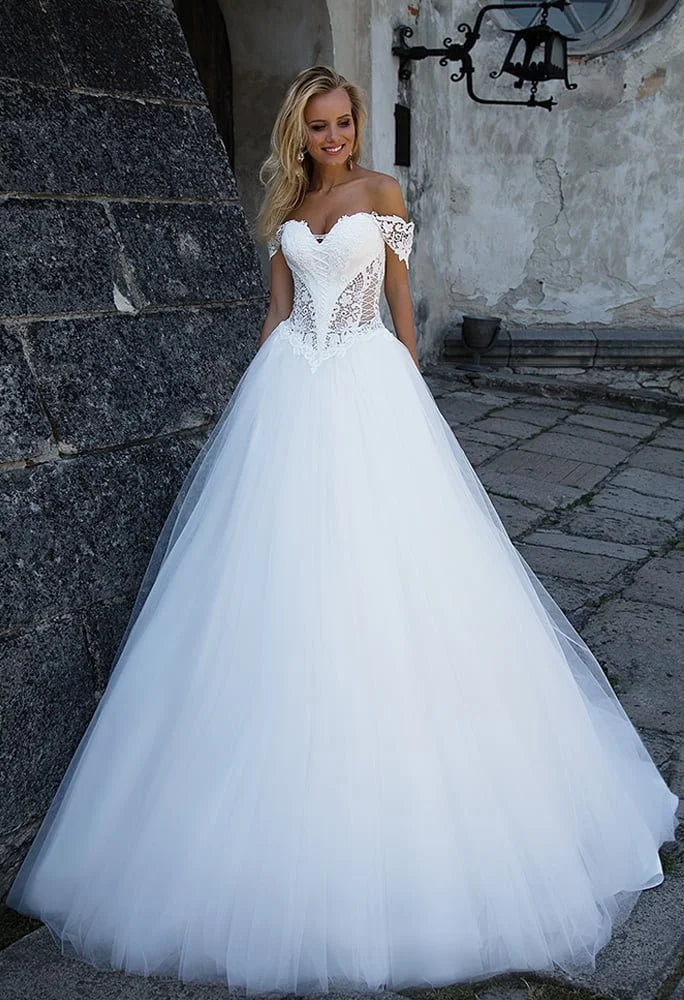 Regal Ball Gown Wedding Dress with Off-the-Shoulder Neckline, Exquisite Lace Detailing, and a Flattering Dropped Waist for a Fairytale Bridal Look