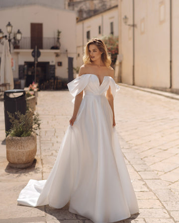 Romantic A-Line Wedding Gown, Off-Shoulder Sleeves, and a Flattering Natural Waistline for an Enchanting Bridal Look