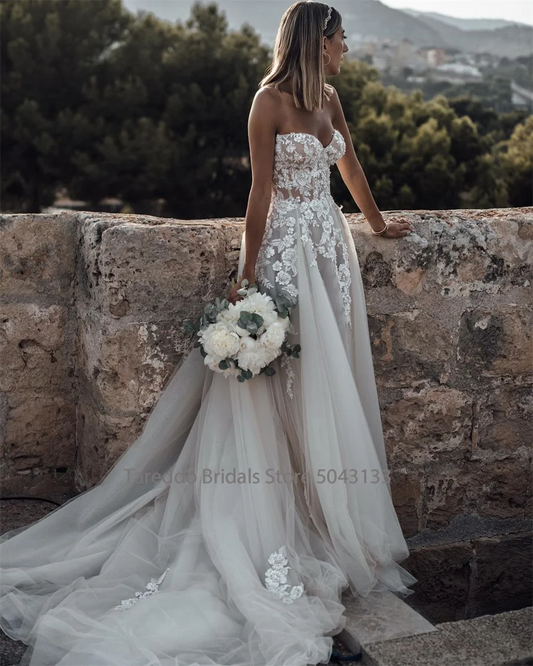 Breathtaking Strapless Wedding Dress Featuring Stunning Crystals Lace Appliques and Flowy A-Line Silhouette Bridal Dress