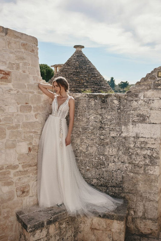 Whimsical Beach Wedding Dress with Strapless V-Neckline, Delicate Lace Details & Flowing A-Line Silhouette for a Fairy-Tale Bridal Look