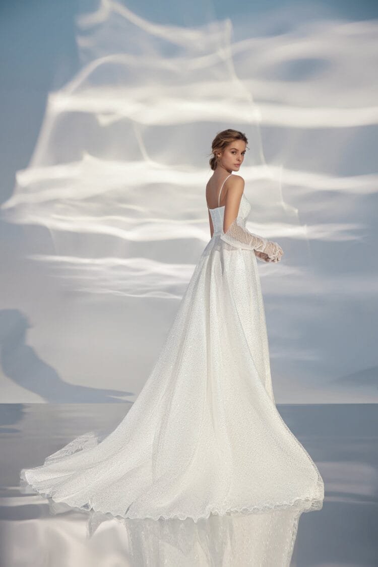 Sleek A-Line Wedding Gown with Straps, V-Neckline, Delicate Lace Embellishment, and a Natural Waistline for a Minimalist and Elegant Bridal Look