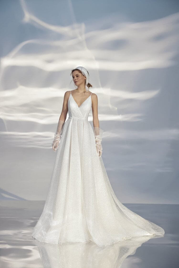 Sleek A-Line Wedding Gown with Straps, V-Neckline, Delicate Lace Embellishment, and a Natural Waistline for a Minimalist and Elegant Bridal Look