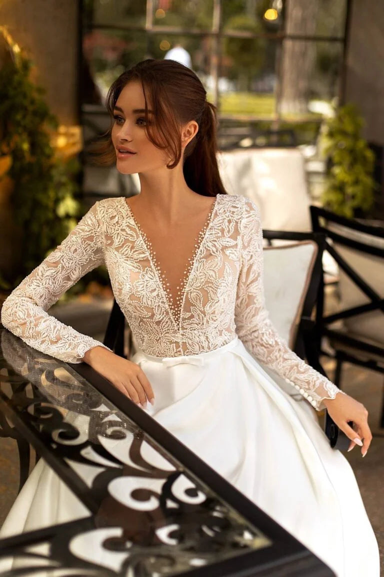 Timeless A-Line Wedding Gown with Long Sleeves, V-Neckline, and a Flattering Dropped Waist for an Elegant Bridal Look