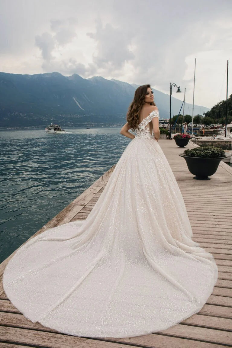 Regal Ball Gown Wedding Dress with Off-the-Shoulder Design, Queen Anne Neckline, and a Flattering Natural Waistline for a Stunning Bridal Look