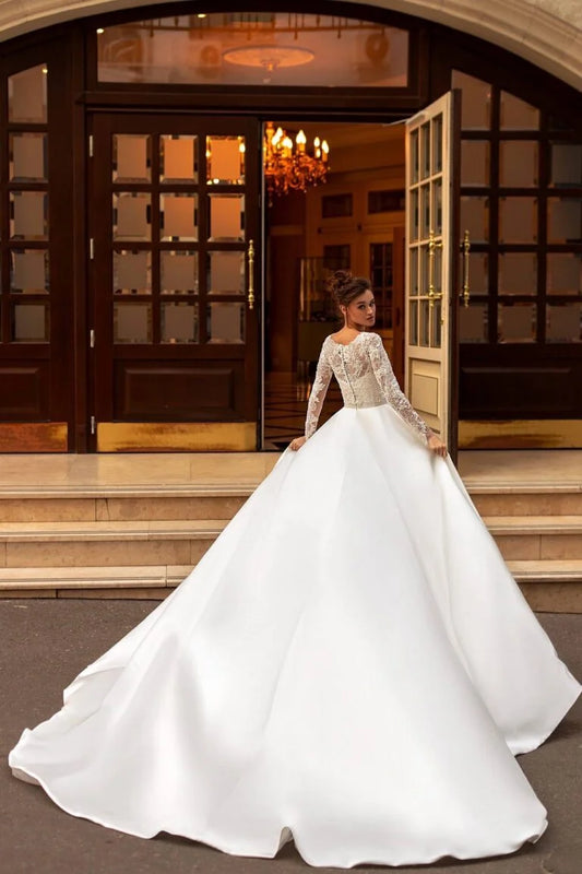 Graceful A-Line Wedding Gown with Long Sleeves, High-Neckline, and a Flattering Dropped Waist for a Timeless and Elegant Bridal Look