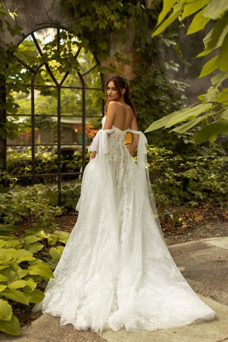 Elegant A-Line Wedding Gown with Off-Shoulder Neckline, Delicate Beaded Lace Details, and a Flattering Dropped Waist for a Breathtaking Bridal Look