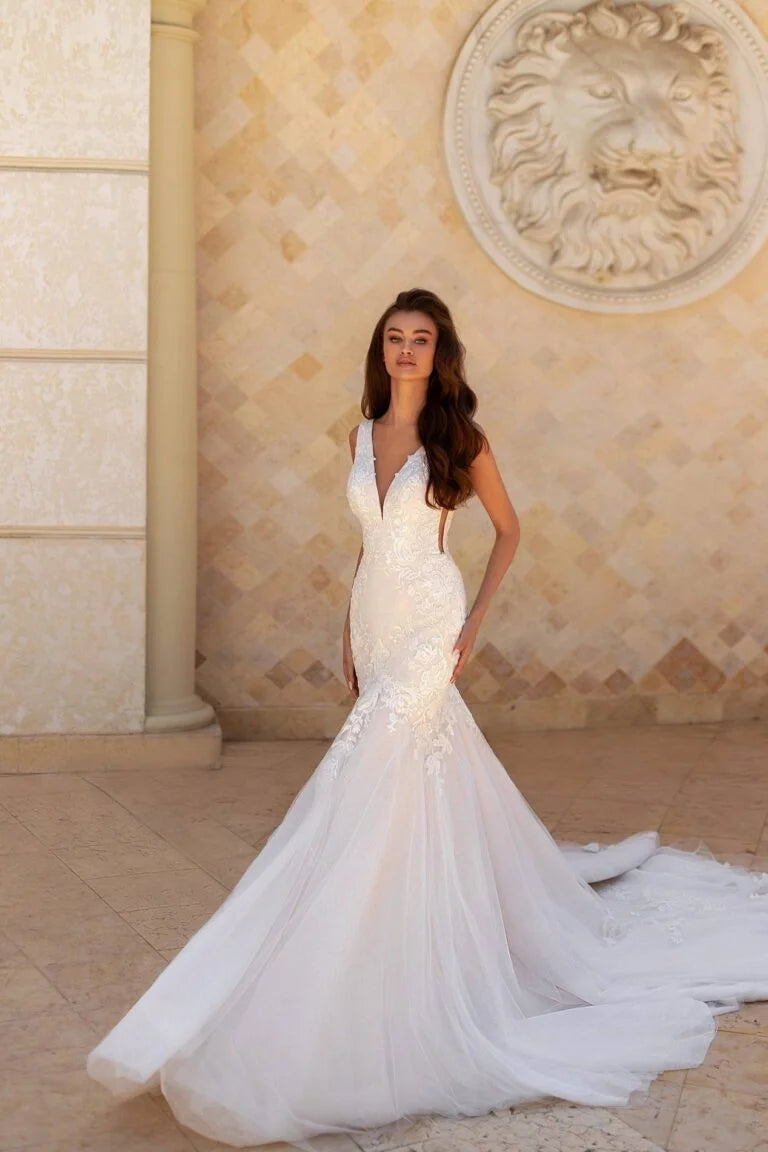 Glamorous Mermaid Wedding Gown with Spaghetti Straps, V-Neckline, and a Flattering Dropped Waist for a Striking Bridal Look