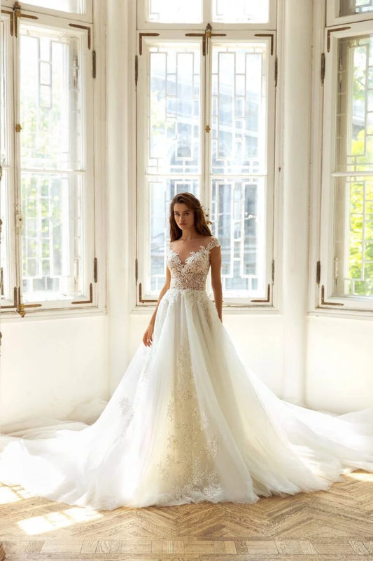 Graceful A-Line Wedding Gown with Cap Sleeves, Off-Shoulder Neckline, and a Flattering Dropped Waist for a Romantic Bridal Look