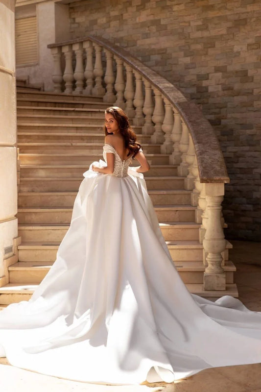 Regal Ball Gown Wedding Dress with Off-Shoulder Neckline, Exquisite Lace Details, and a Flattering Dropped Waist for a Fairytale Bridal Look - Camilla's