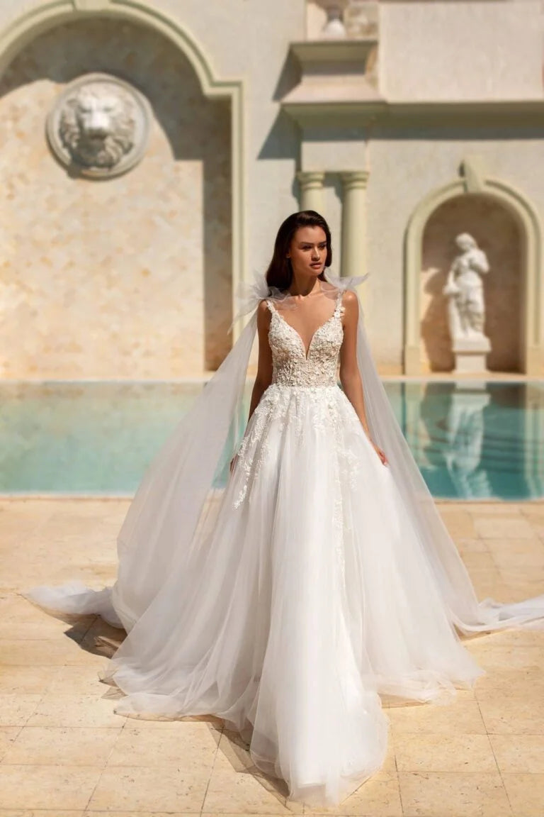 Ethereal A-Line Wedding Gown with Spaghetti Straps, V-Neckline, and a Graceful Dropped Waist for a Romantic Bridal Look