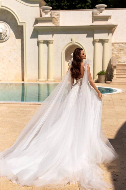 Ethereal A-Line Wedding Gown with Spaghetti Straps, V-Neckline, and a Graceful Dropped Waist for a Romantic Bridal Look